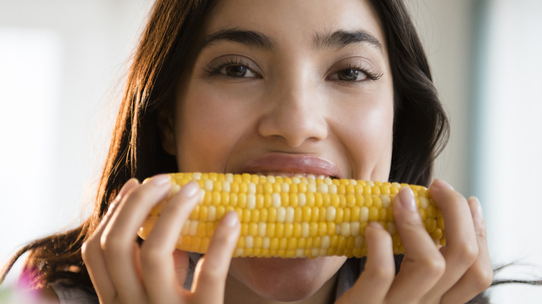 A woman eating corn on the cob