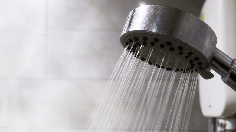 Shower head surrounded by steam