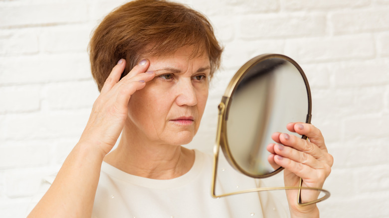 woman looking in mirror