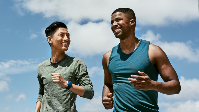 two fit men running outdoors