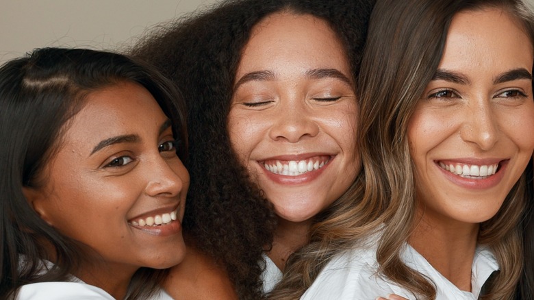 Three smiling young women