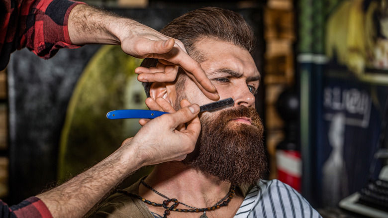 bearded man getting a shave