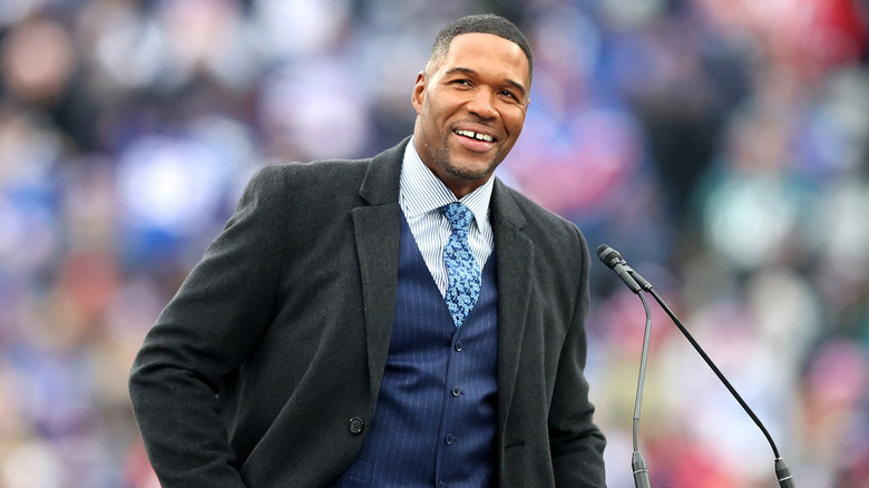 Michael Strahan at a ceremony retiring his number