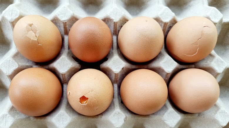 cracked eggs in a carton