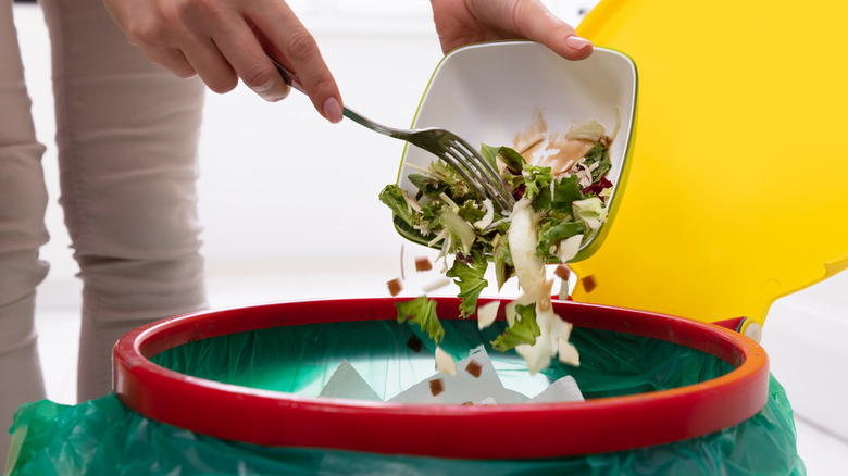 Salad emptied into trash bin