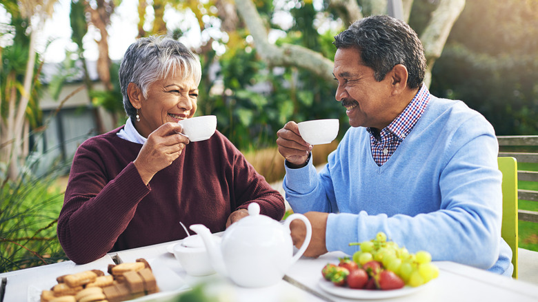 older couple drinking tea outdoors