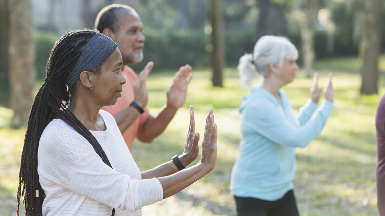 older adults practicing tai chi outdoors