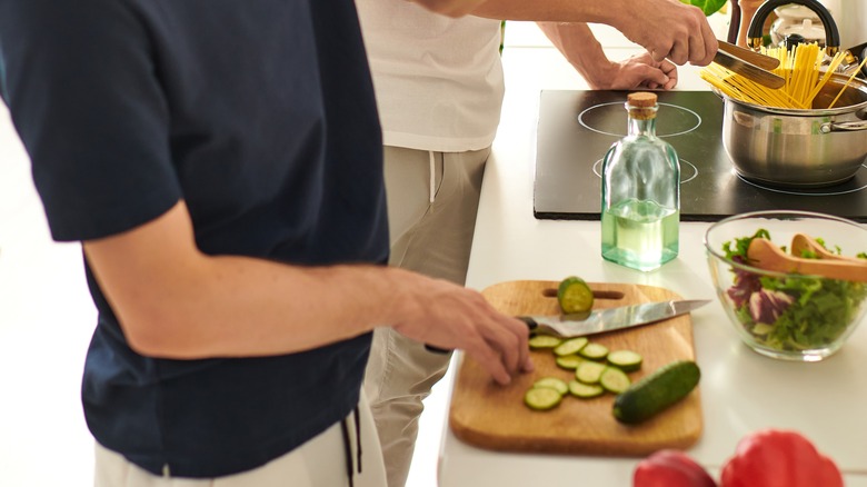 Men making a pasta meal in the kitchen