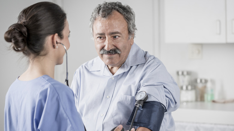 senior man getting blood pressure taken