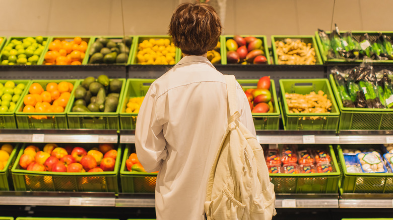 woman shopping for vegetables in store