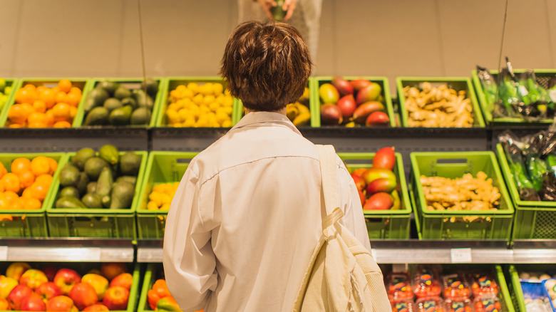 woman shopping for vegetables in store