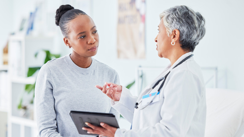 woman discussing with doctor
