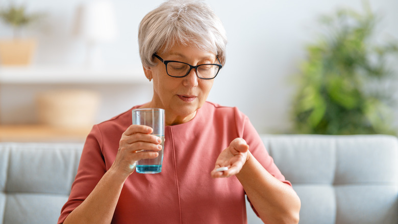 older woman taking vitamin
