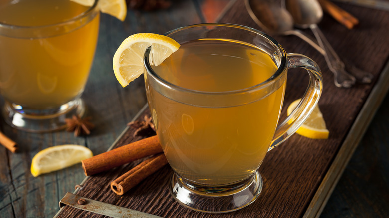 Two hot toddies garnished with lemons