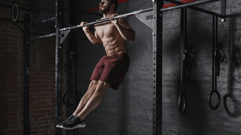 man doing pull-up at the gym