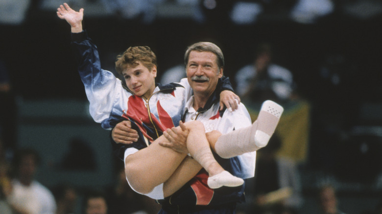 Injured Kerri Strug being carried coach