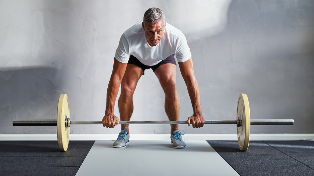 man lifting barbell