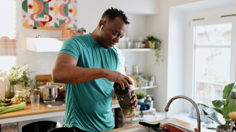 man blending a smoothie