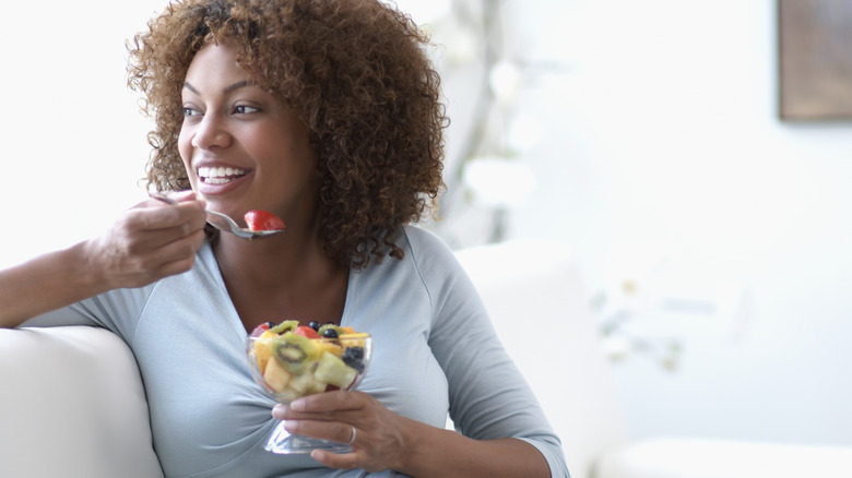 Woman eating a fruit salad