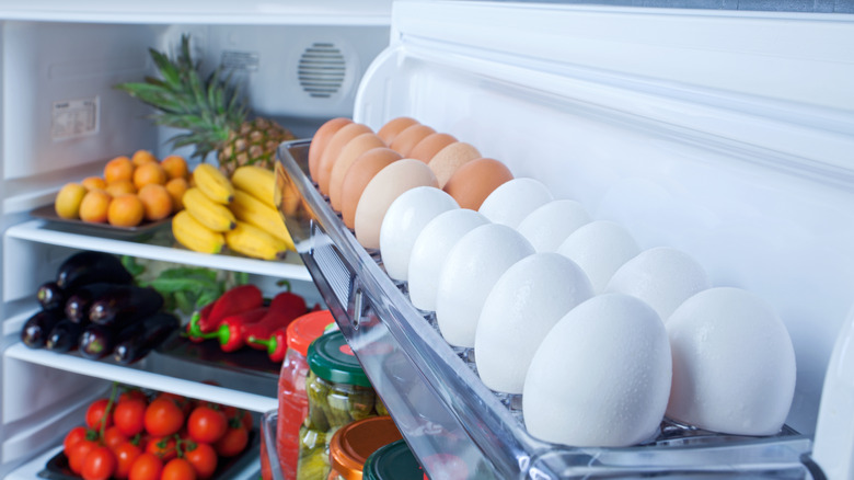 White and brown eggs on a refrigerator door