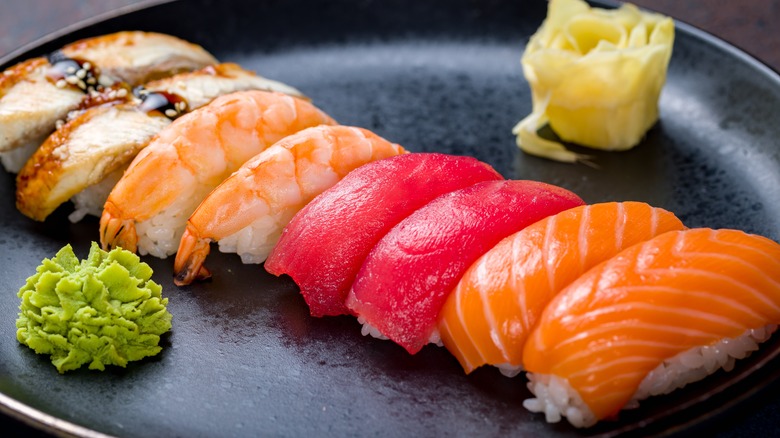 Assorted sushi topped with salmon, tuna, shrimp, and eel