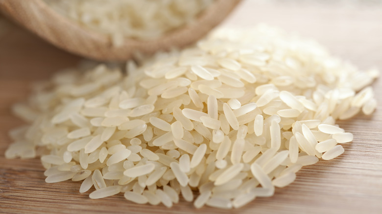 Uncooked rice on wooden table