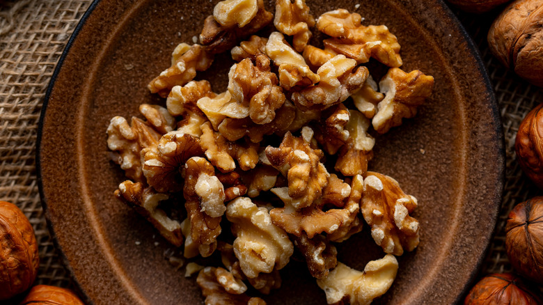 A bowl of walnuts sitting on a table