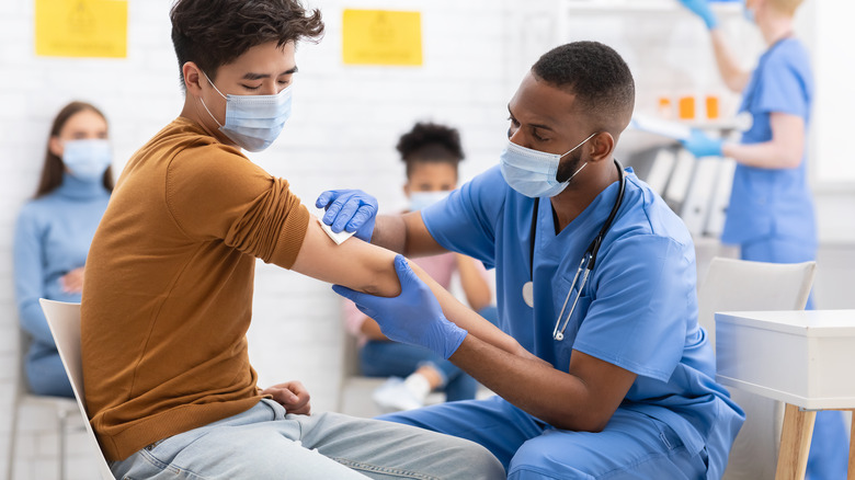 medical professional wiping down arm of patient