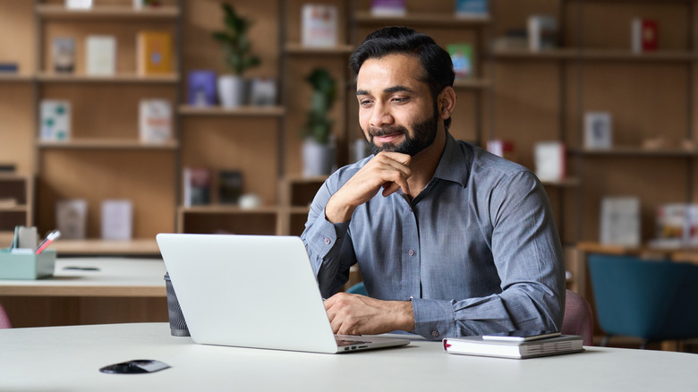 Man sitting at desk laptop