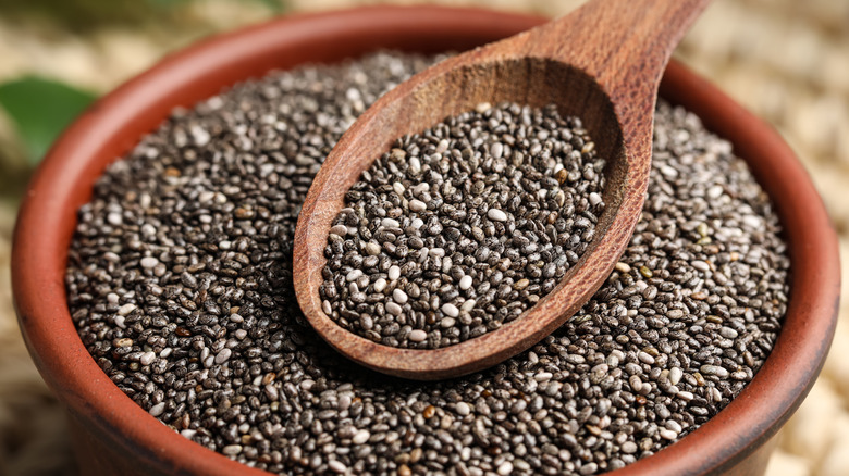 Chia seeds on wooden bowl and spoon