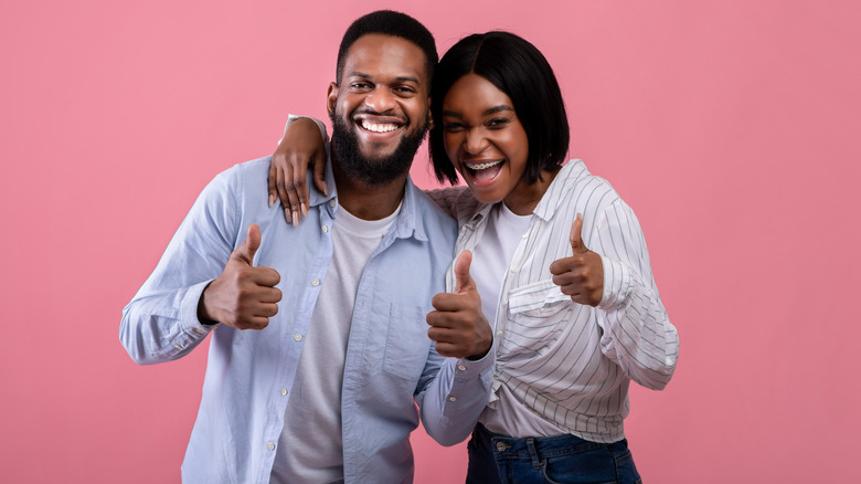 couple with thumbs up