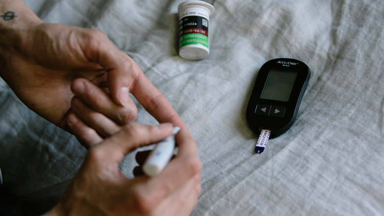 Diabetic woman testing blood sugar levels