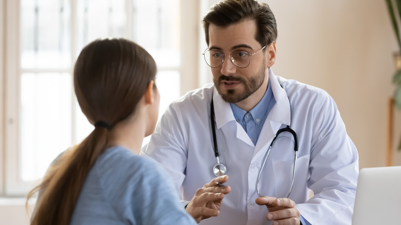 woman talking to male doctor