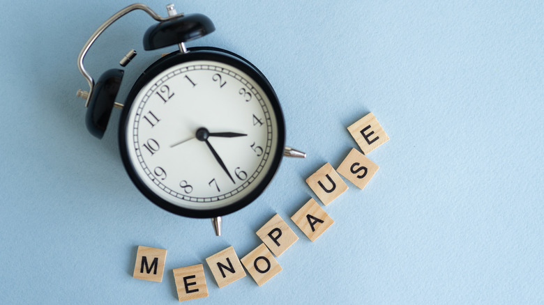 Clock with blocks spelling "menopause"