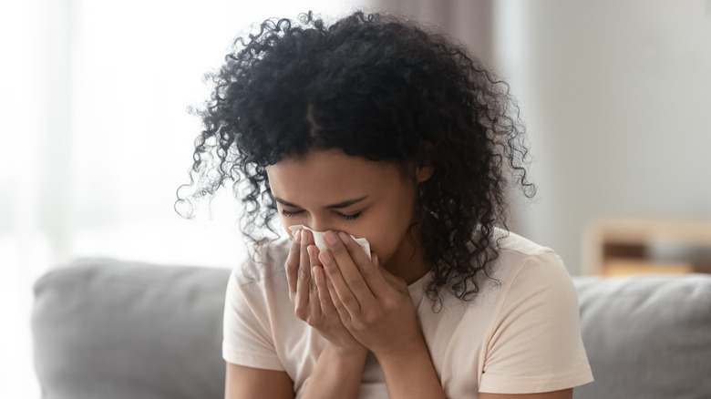 woman sneezing