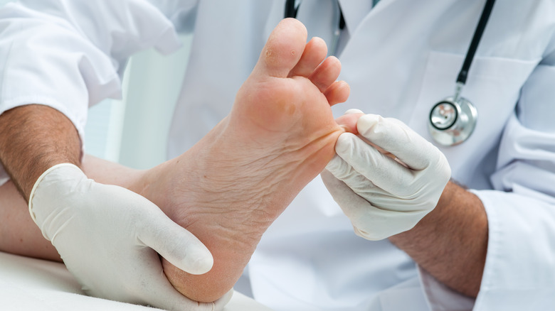 doctor examining the foot of a patient