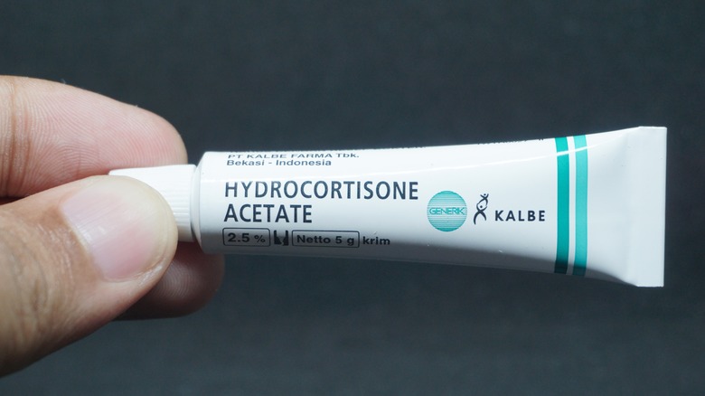 hand holding hydrocortisone cream