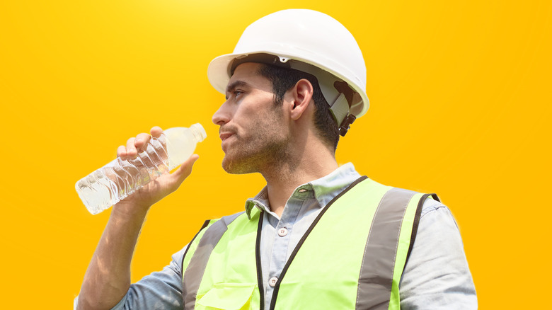 Construction worker drinking water 