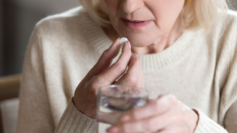 woman taking pill