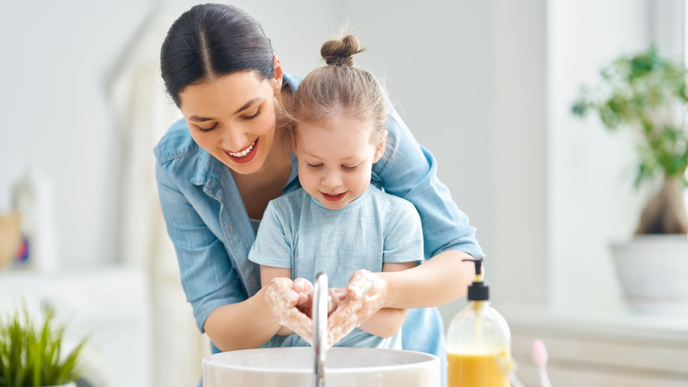 mother and daughter at sink