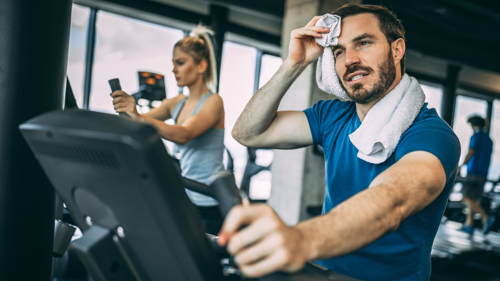 Cycling man, wiping away sweat from brow