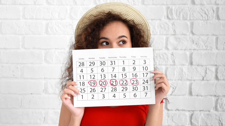 woman holding menstrual calendar