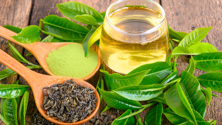 dried green tea leaves with green tea powder and tea