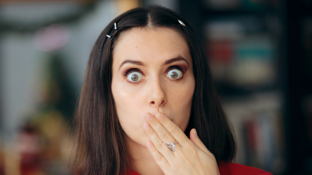 woman covering mouth