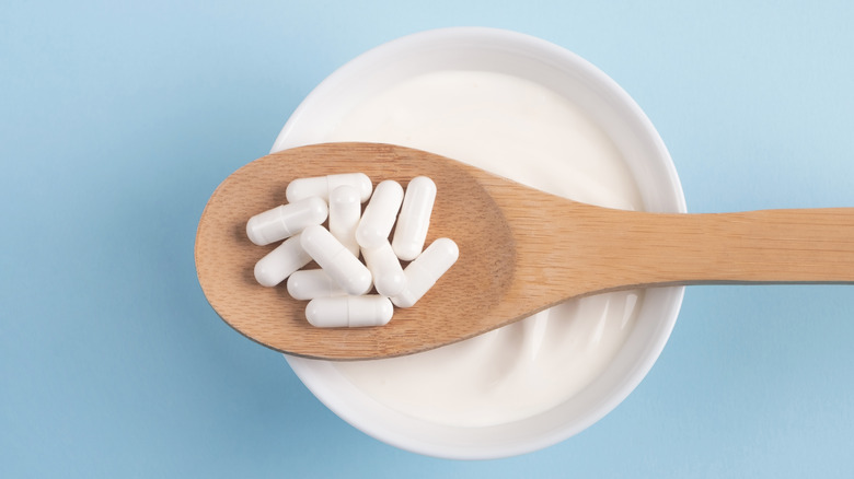 probiotics on a spoon over yogurt