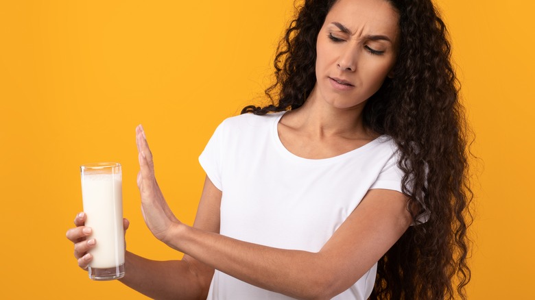 Woman refusing glass of milk