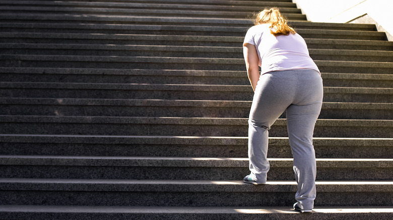 Woman out of breath on staircase