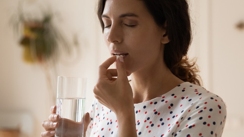 Woman taking antiviral flu medication