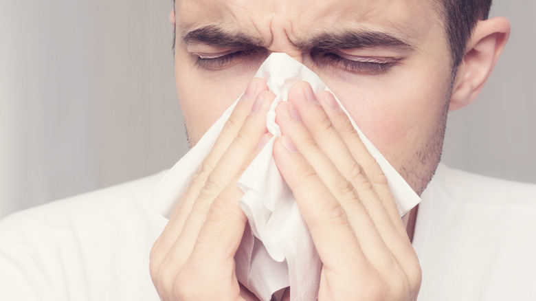 Man blowing his nose