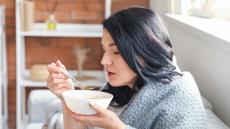 Woman eating chicken soup